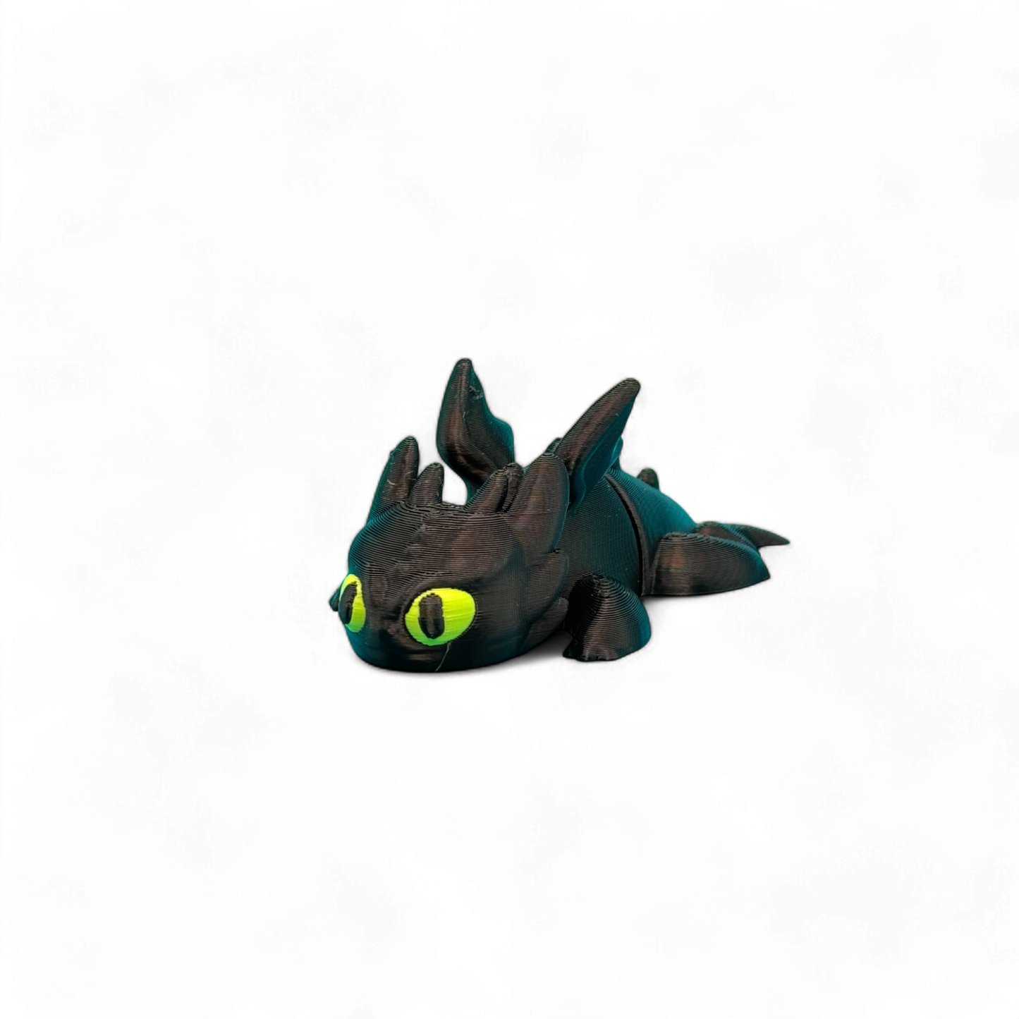 3D-Geprinte toothless flexi sleutelhanger, zwart lichaam met gif groene ogen, zijkant vooraanzicht
